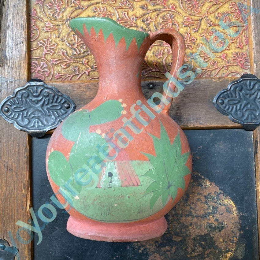 https://yourgreatfinds.net/cdn/shop/files/old-mexican-terracotta-pitcher-with-hand-painted-design-pottery-274_1200x.jpg?v=1682439698
